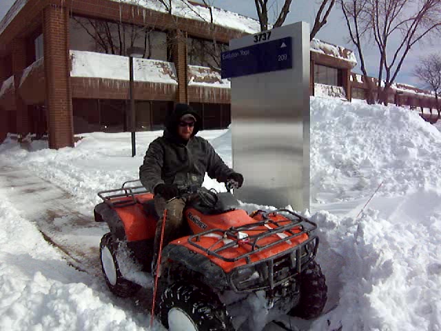 ATV with Plow Used for Snowplowing Cleveland Sidewalks