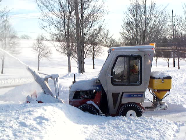 Snow Blower Spreader Removing Snow and Spreading Salt in Cleveland Parking Lot